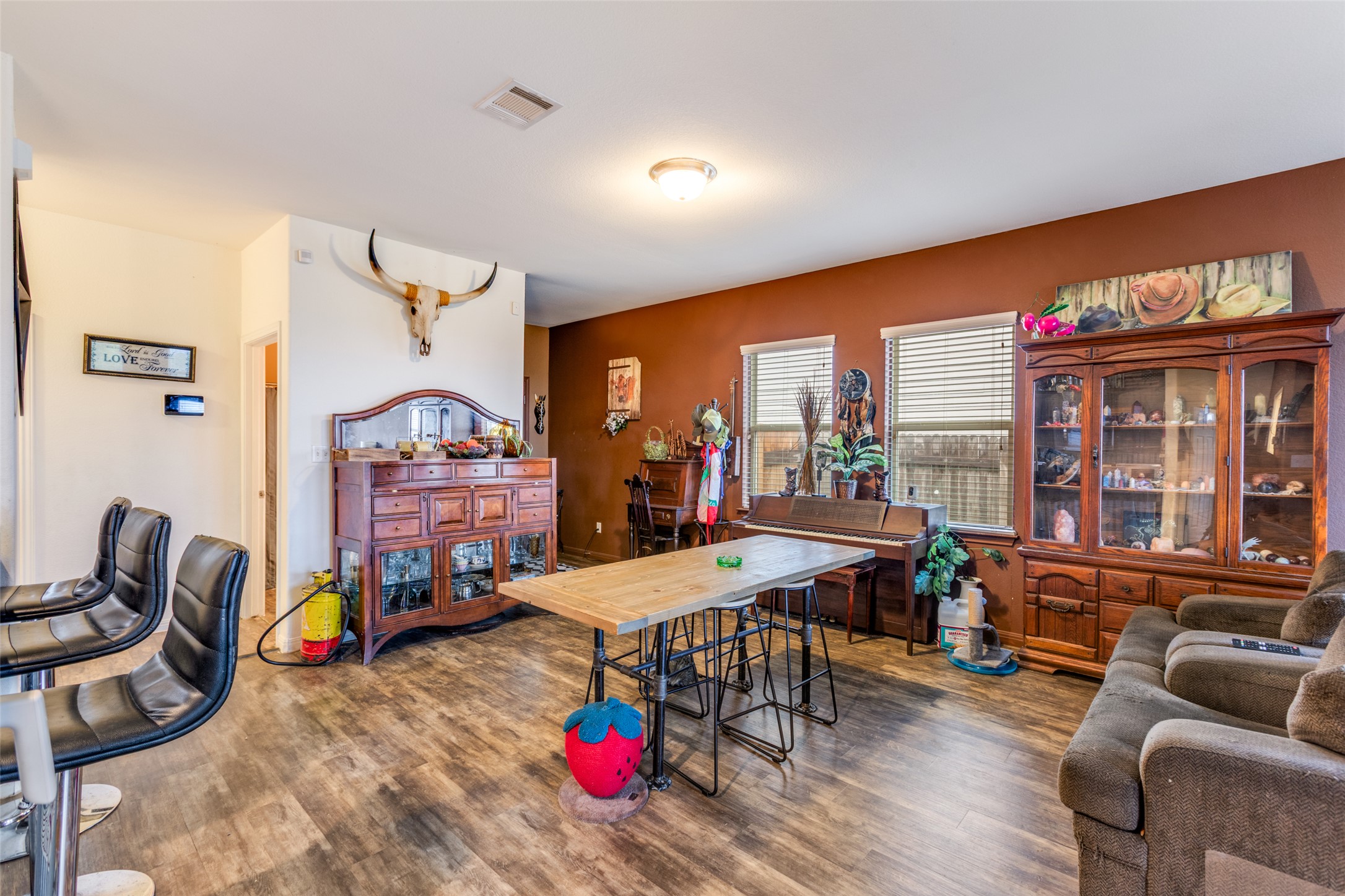 13909 Sherri Berry Way Manor, TX 78653 - Photo 16 of 28 Open-concept living area featuring wood-finish flooring, warm-toned accent walls, and recessed lighting