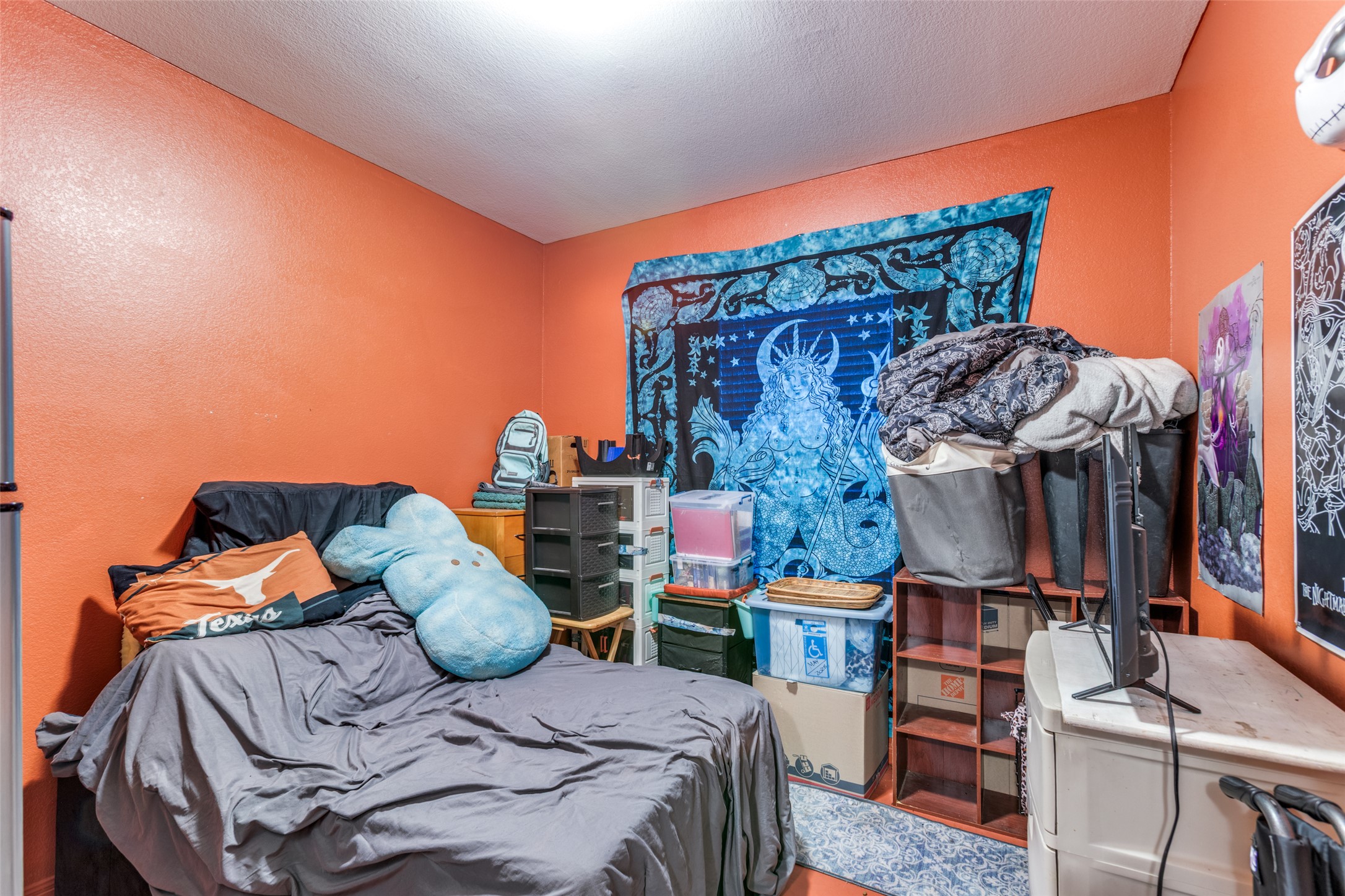 13909 Sherri Berry Way Manor, TX 78653 - Photo 19 of 28 Room featuring textured orange walls and a white ceiling