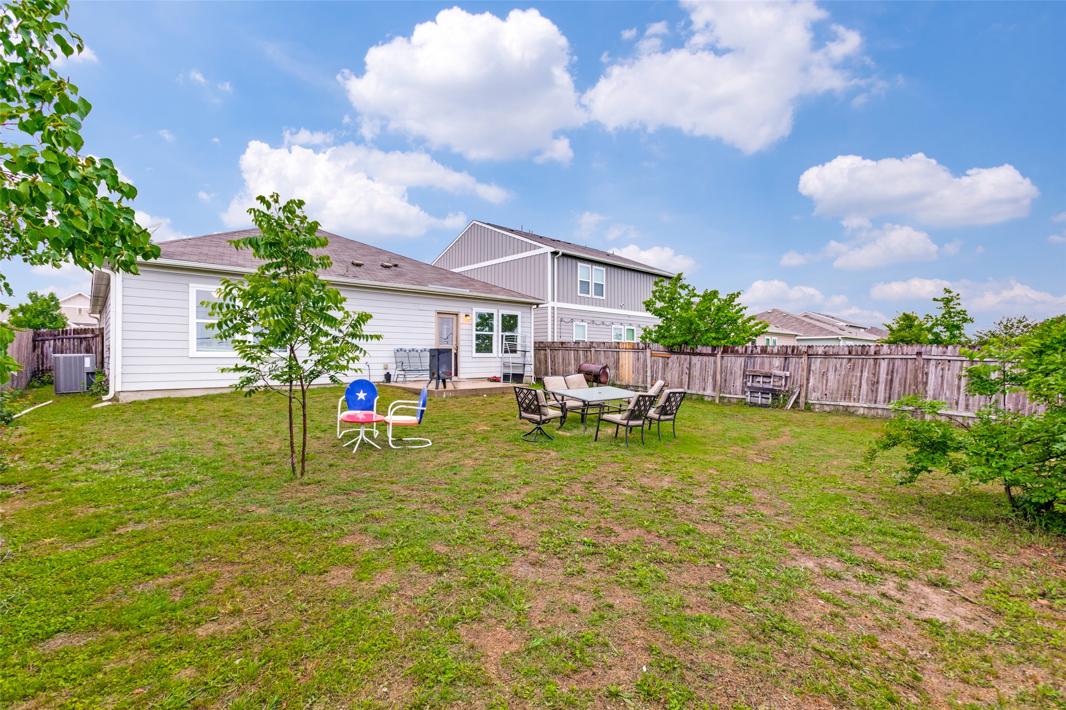 13909 Sherri Berry Way Manor, TX 78653 - Photo 22 of 28 Fenced backyard with a concrete patio