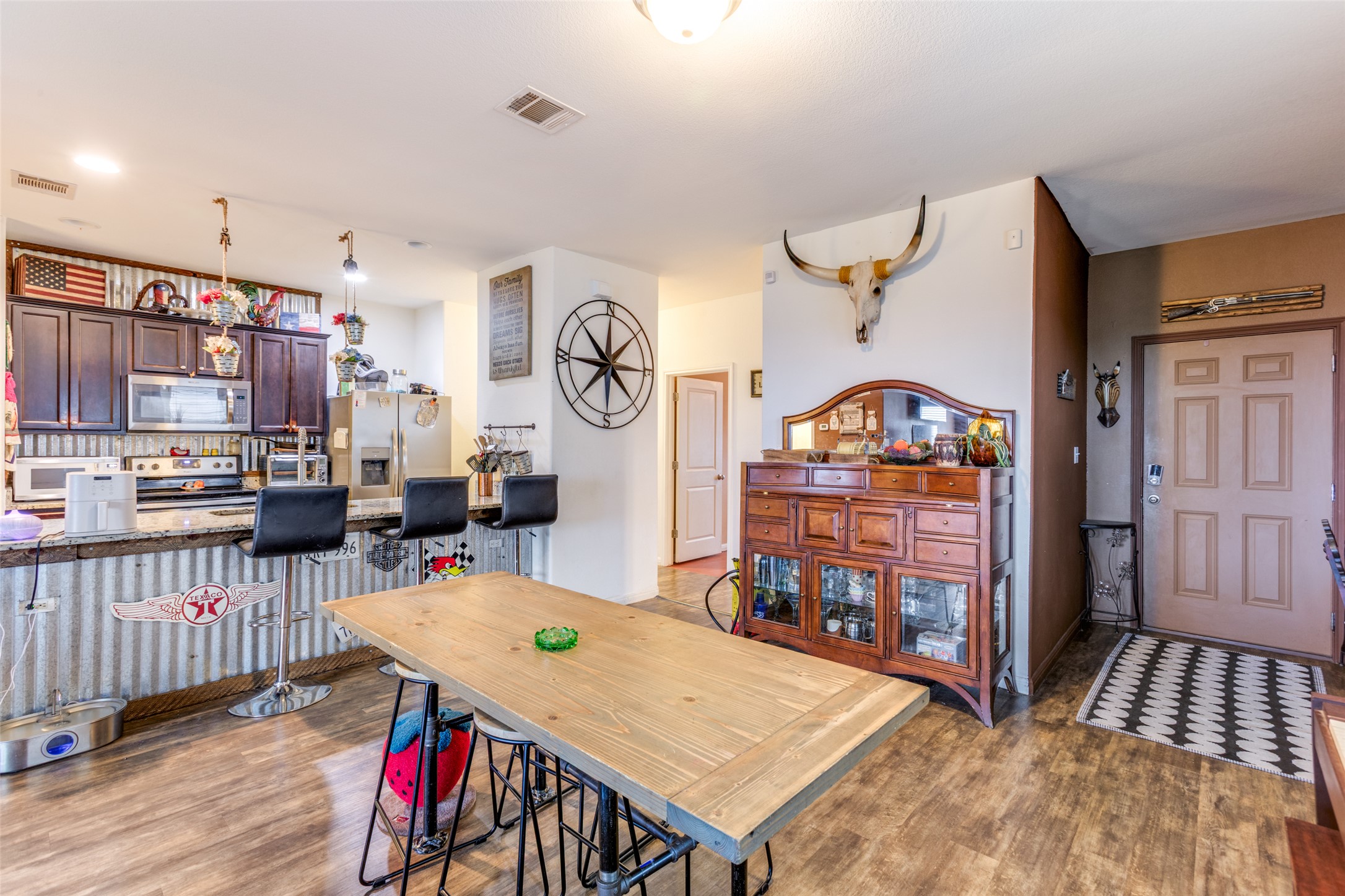 13909 Sherri Berry Way Manor, TX 78653 - Photo 6 of 28 Open-concept kitchen and dining area featuring wood-finish flooring
