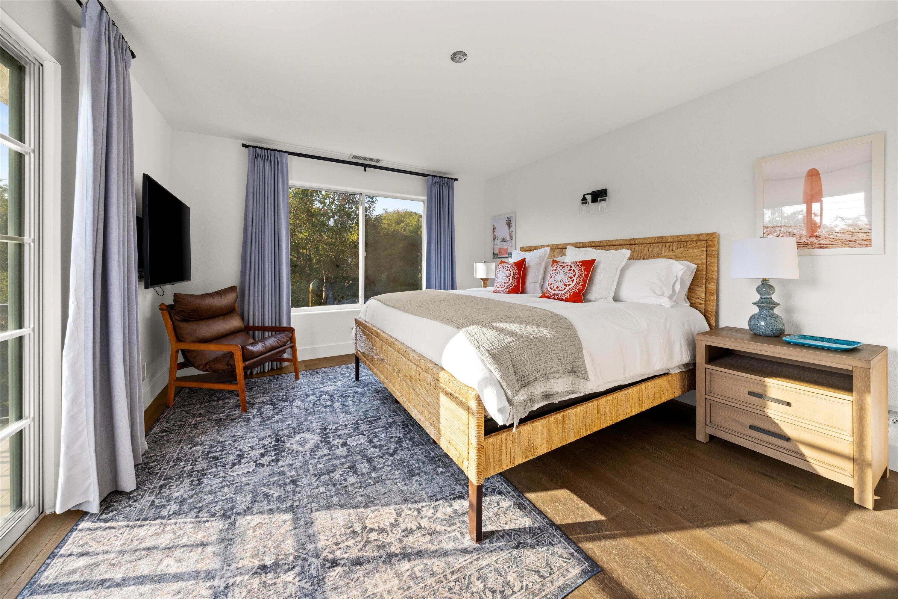1378 Sycamore Canyon Road Santa Barbara, CA 93108 - Photo 12 of 28 a bedroom with a bed and a flat tv screen on dresser