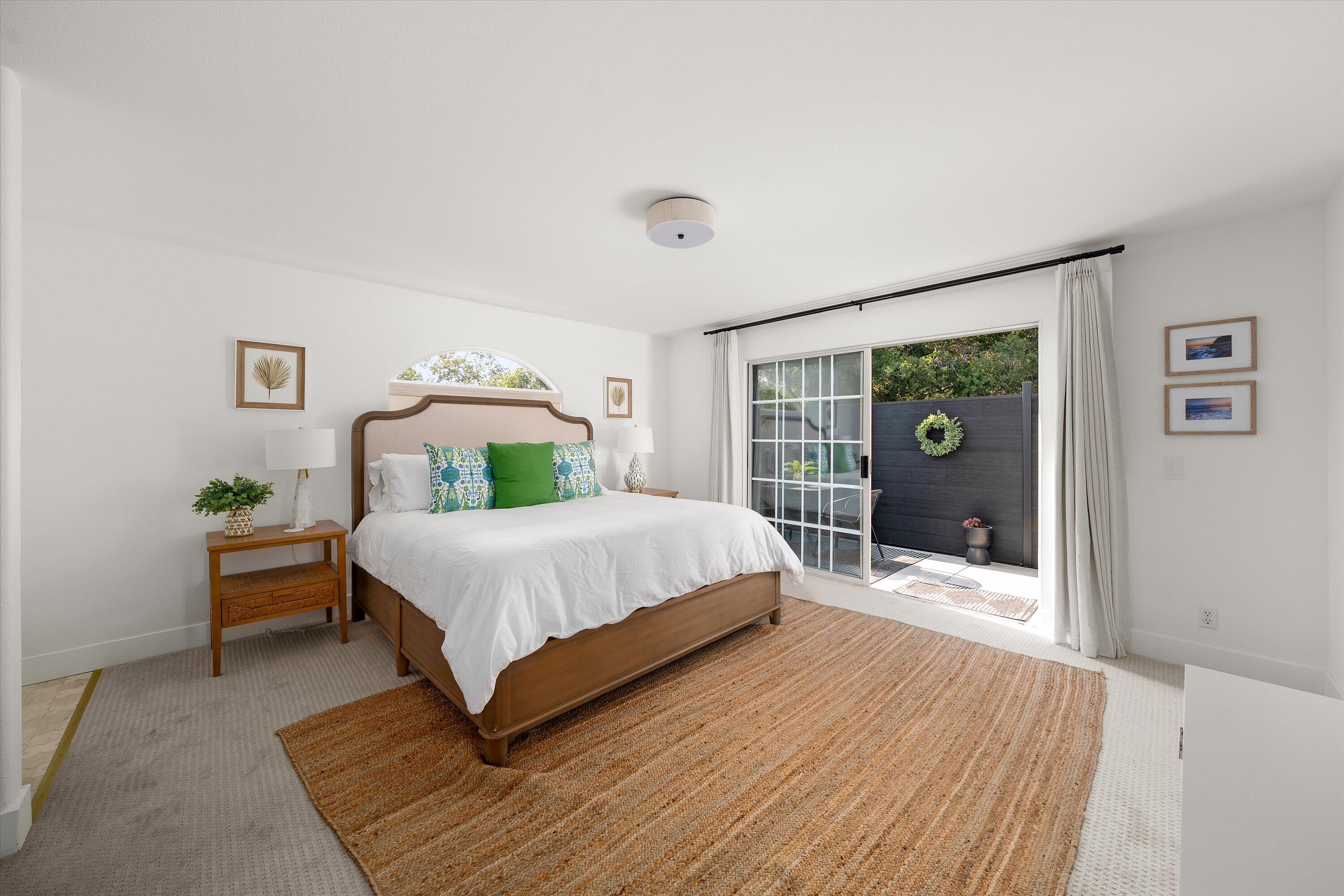 1378 Sycamore Canyon Road Santa Barbara, CA 93108 - Photo 21 of 28 a bedroom with a bed lamp and a large window
