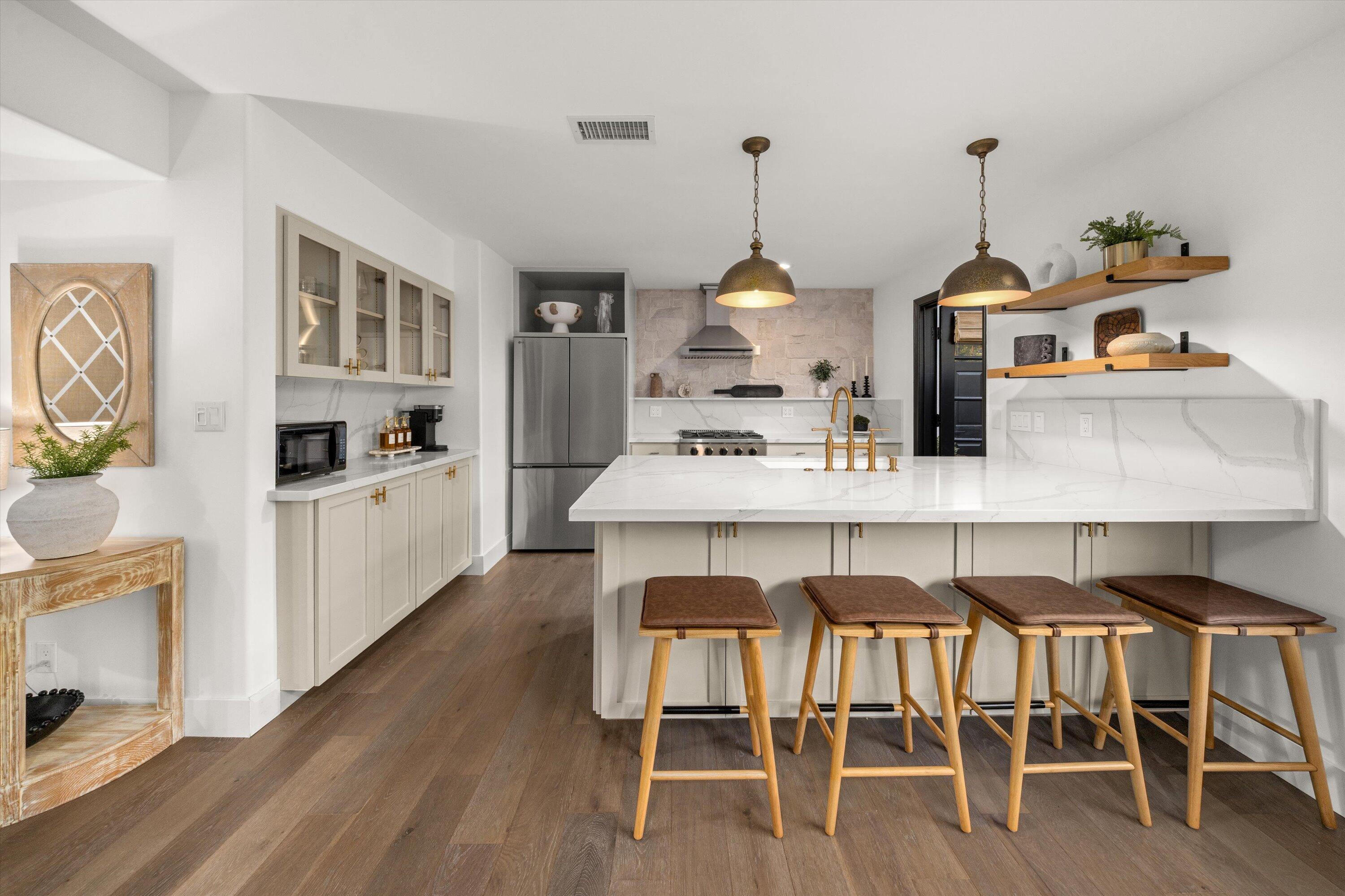 1378 Sycamore Canyon Road Santa Barbara, CA 93108 - Photo 6 of 28 a kitchen with a dining table chairs and white cabinets