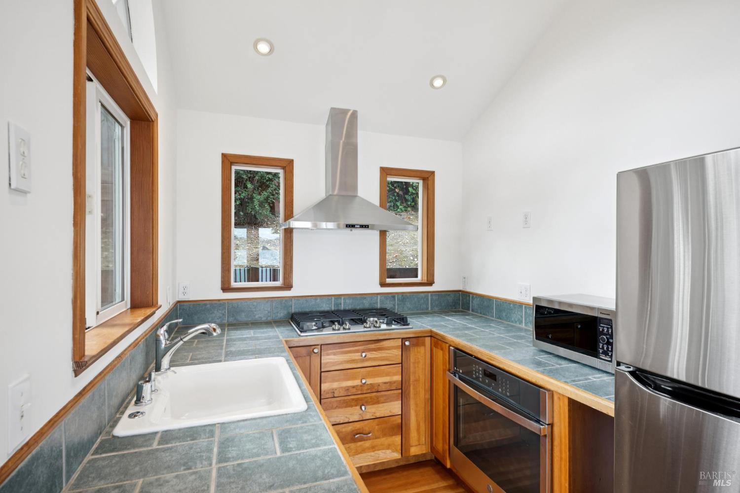 177 Oak Drive San Rafael, CA 94901 - Photo 11 of 27 a bathroom with a granite countertop sink and a large mirror
