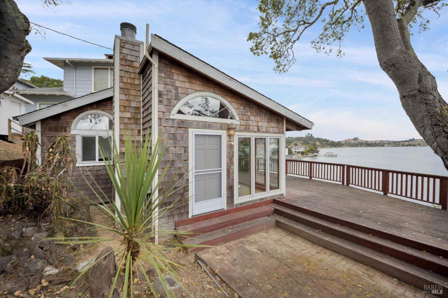 177 Oak Drive San Rafael, CA 94901 - Photo 3 of 27 a view of a house with a wooden deck and a floor to ceiling window