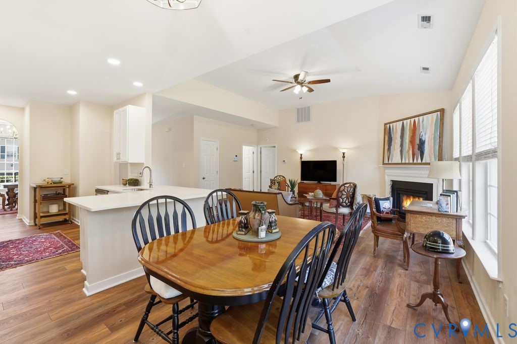 13924 Krim Point Road Midlothian, VA 23114 - Photo 12 of 48 a view of a dining room with furniture a fireplace and wooden floor