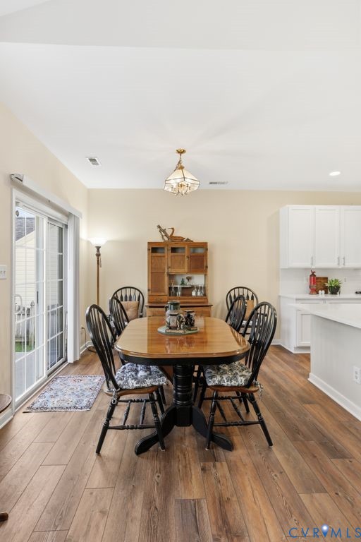 13924 Krim Point Road Midlothian, VA 23114 - Photo 13 of 48 a view of a dining room with furniture and wooden floor