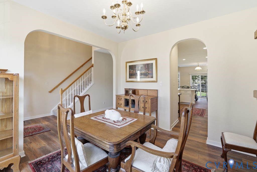 13924 Krim Point Road Midlothian, VA 23114 - Photo 16 of 48 a view of a dining room with furniture and a chandelier