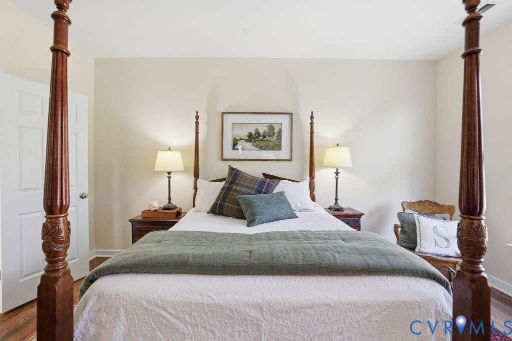 13924 Krim Point Road Midlothian, VA 23114 - Photo 19 of 48 a bedroom with a bed and a night stand