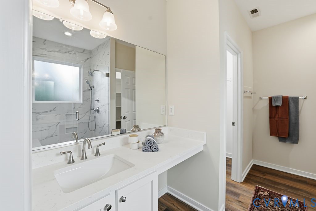 13924 Krim Point Road Midlothian, VA 23114 - Photo 20 of 48 a bathroom with a sink vanity and mirror