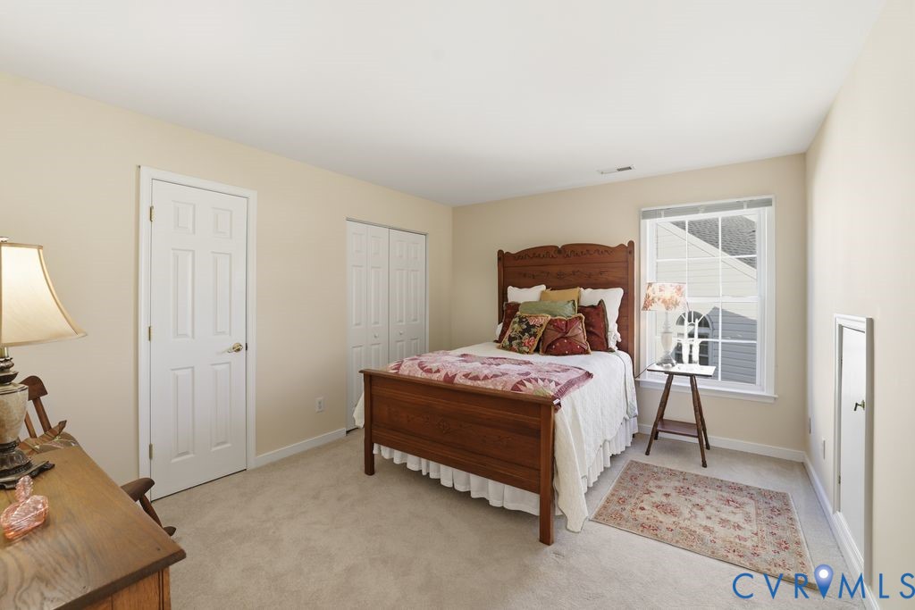 13924 Krim Point Road Midlothian, VA 23114 - Photo 28 of 48 a bedroom with a bed and wooden floor