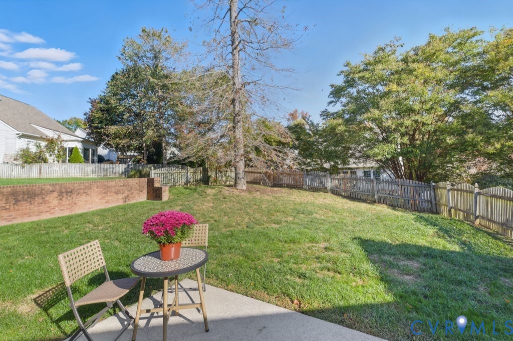 13924 Krim Point Road Midlothian, VA 23114 - Photo 31 of 48 a view of a backyard with table and chairs and potted plants