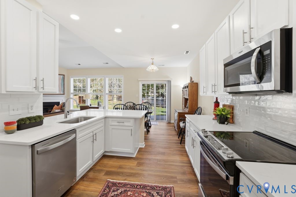 13924 Krim Point Road Midlothian, VA 23114 - Photo 4 of 48 a kitchen that has a lot of cabinets in it with stainless steel appliances granite countertop a stove top oven a sink a counter space and cabinets