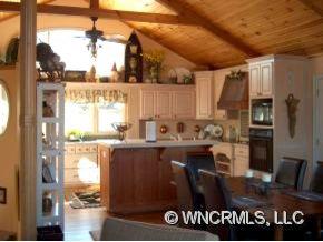 901 Hawk Ridge Drive Mill Spring, NC 28756 - Photo 4 of 12 a kitchen with a sink a refrigerator and window