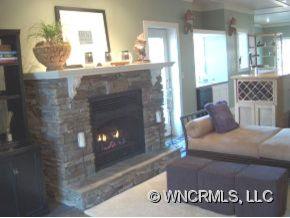 901 Hawk Ridge Drive Mill Spring, NC 28756 - Photo 7 of 12 a living room with furniture and a fireplace