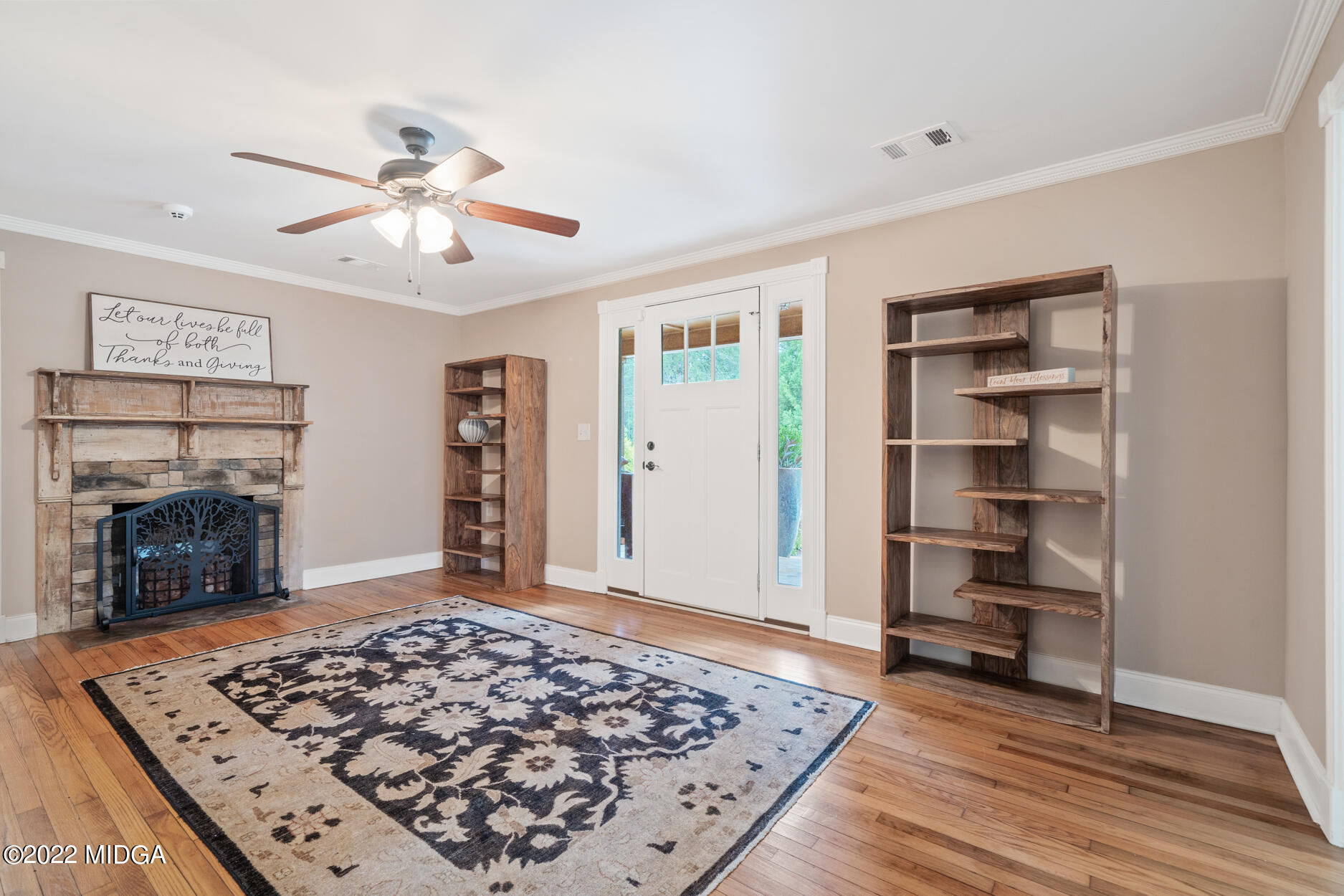 265 Blount Road Forsyth, GA 31029 - Photo 36 of 70 a view of a livingroom with wooden floor a ceiling fan and a window
