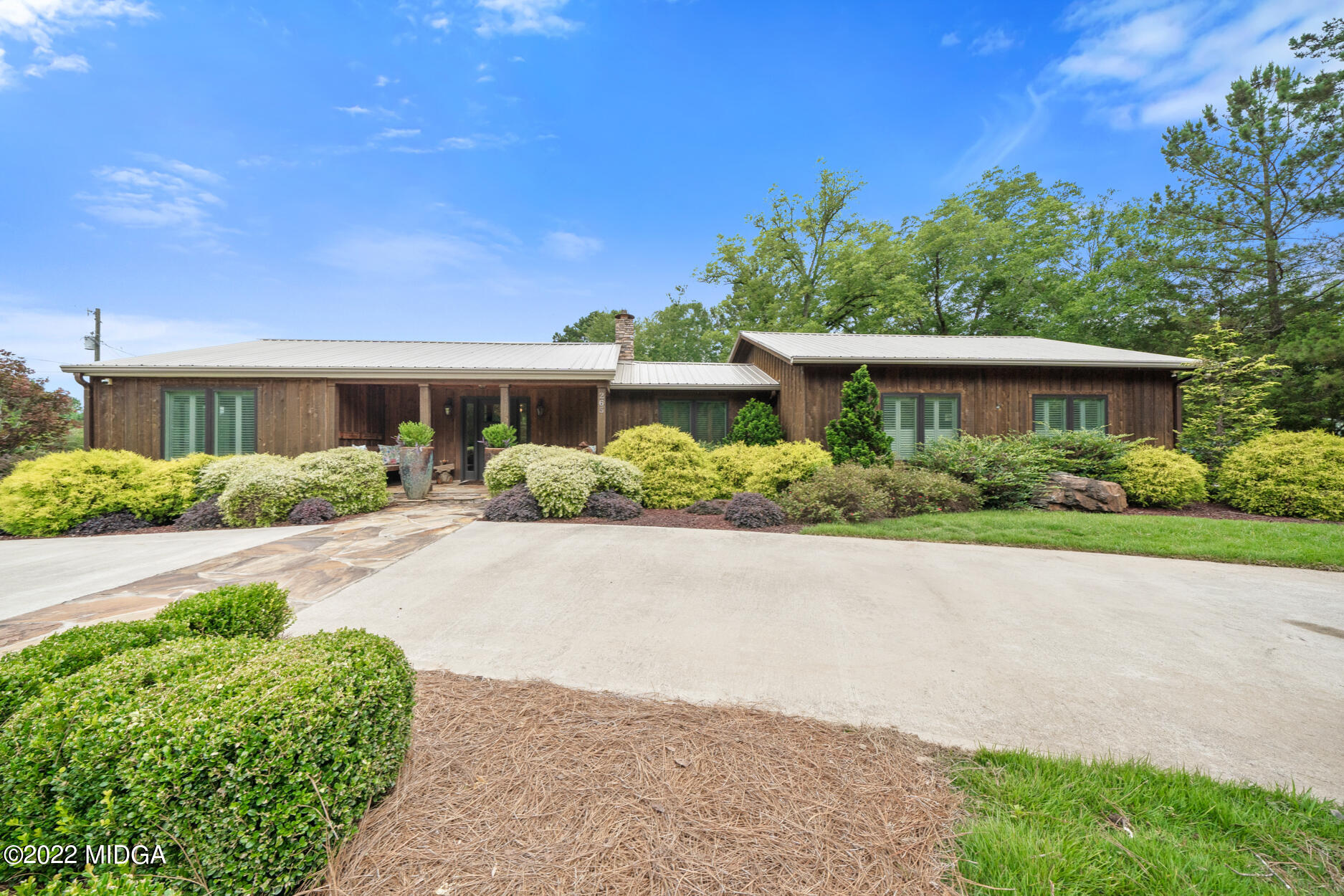 265 Blount Road Forsyth, GA 31029 - Photo 5 of 70 a front view of a house with a yard and potted plants