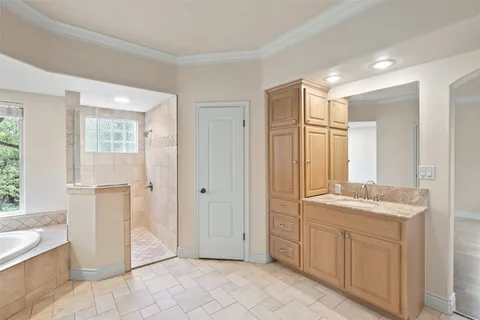 a bathroom with a double vanity sink a mirror and a bathtub