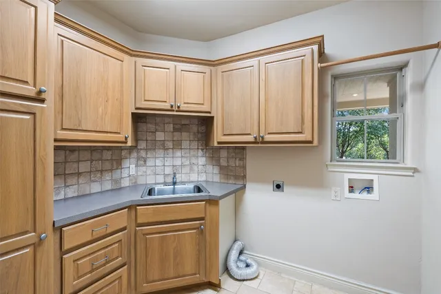 a kitchen with stainless steel appliances white cabinets and a window