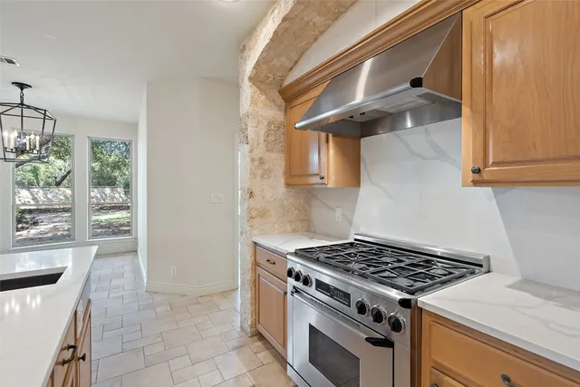 a kitchen with stainless steel appliances granite countertop a stove and a sink