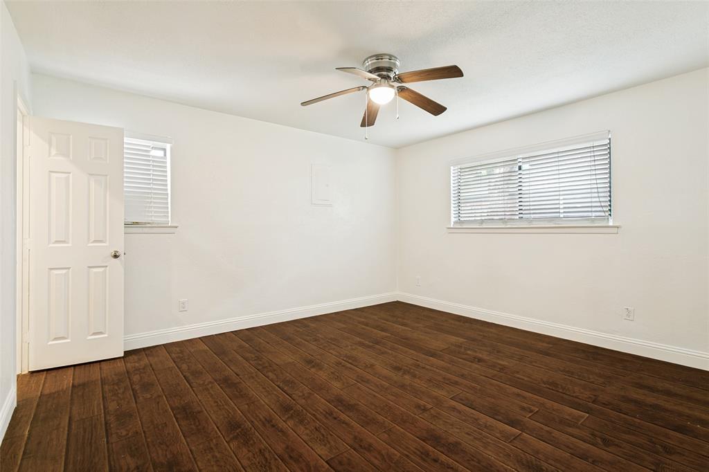 1904 Old Kirk Road Bedford, TX 76022 - Photo 21 of 25 a view of an empty room with wooden floor and a ceiling fan