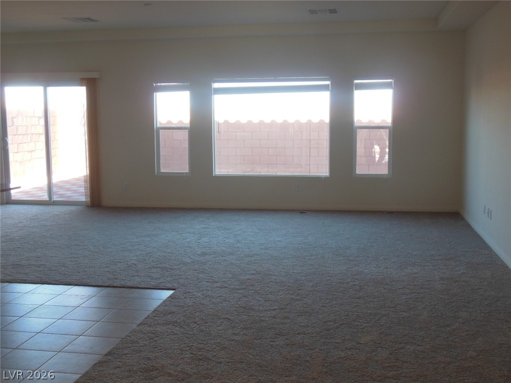 6390 Jackson Spring Road Las Vegas, NV 89118 - Photo 2 of 27 A spacious living area awaits your personal touch, offering abundant light and direct outdoor access.