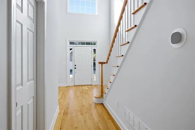 a room with pool table windows and wooden floor