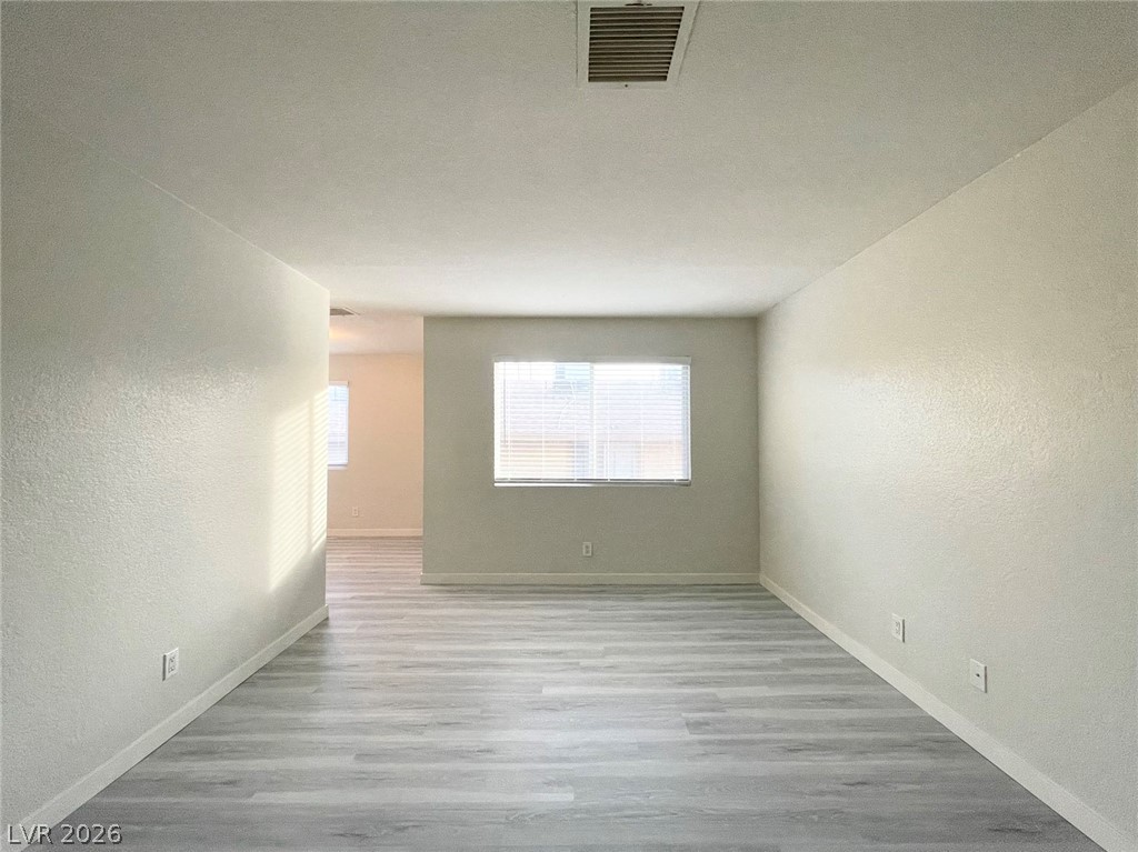 1834 North Decatur Boulevard, Unit 204 Las Vegas, NV 89108 - Photo 3 of 17 The generously sized living area boasts contemporary wood-look flooring and ample natural light.