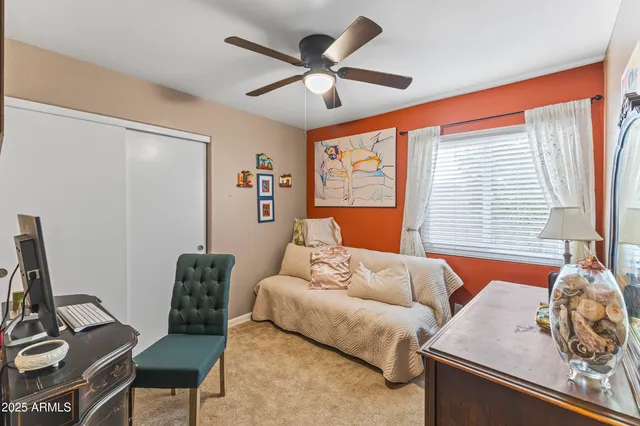 a bedroom with a bed and a painting on the wall