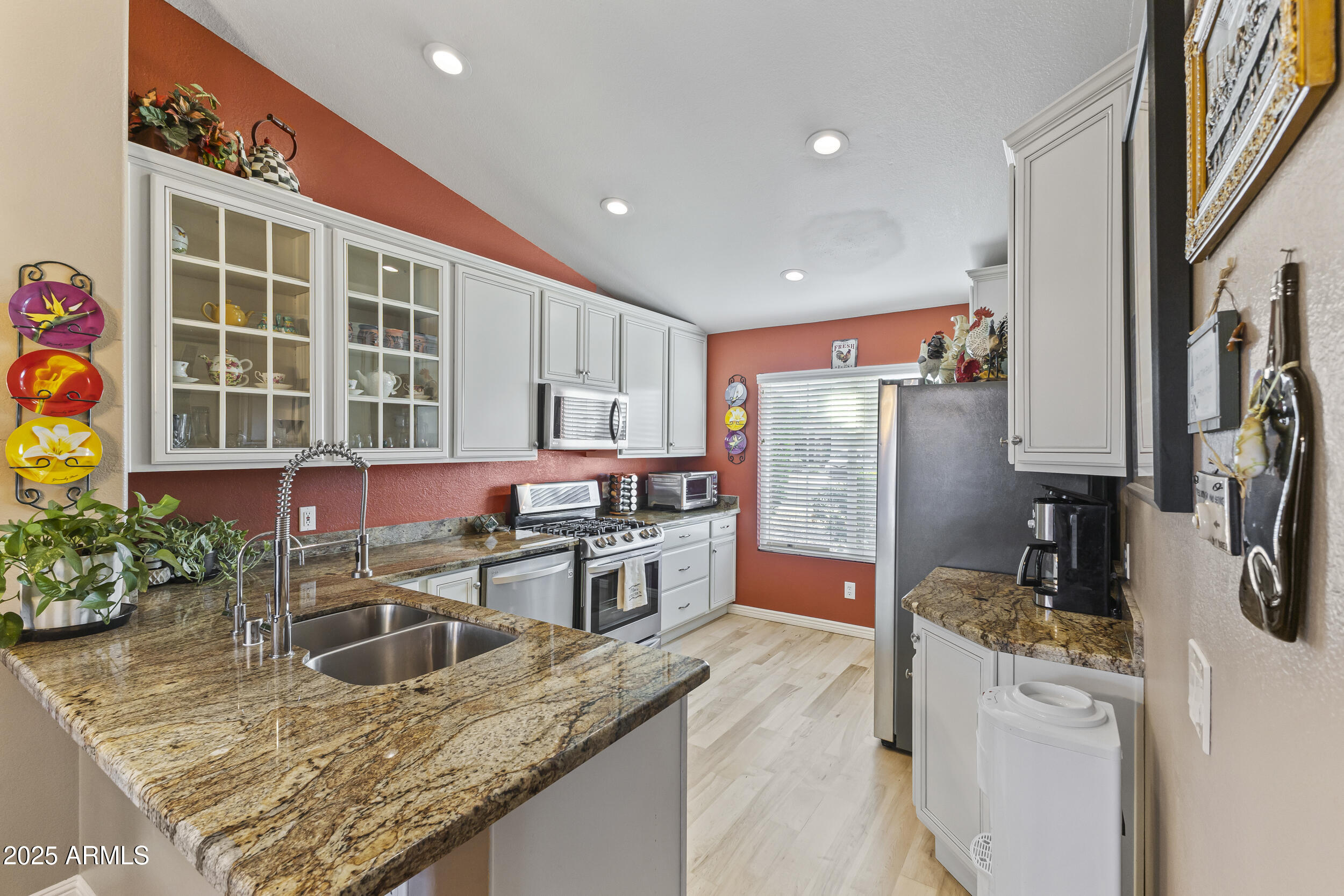 922 West Hudson Way Gilbert, AZ 85233 - Photo 6 of 27 a kitchen with stainless steel appliances granite countertop sink stove top oven and cabinets