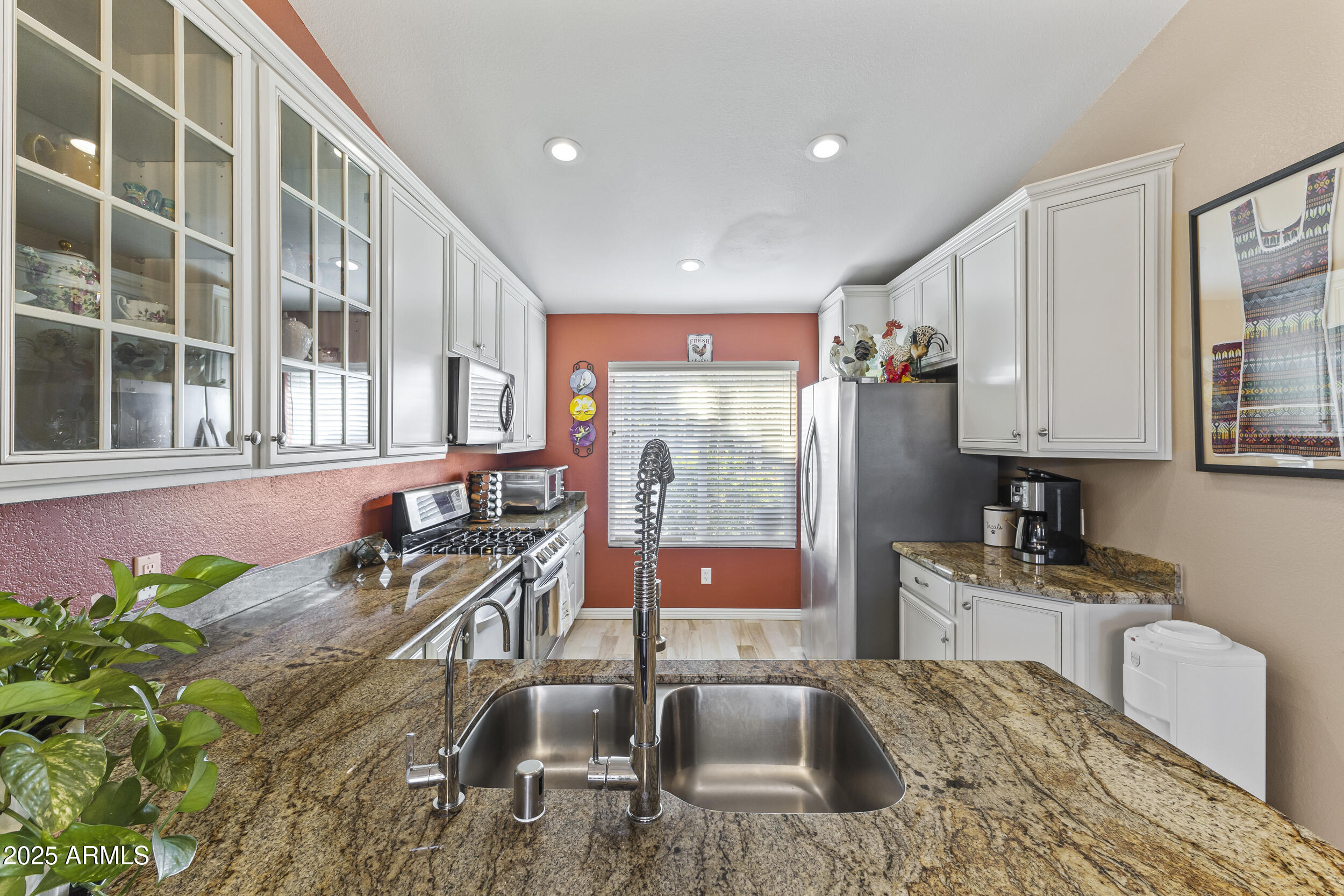 922 West Hudson Way Gilbert, AZ 85233 - Photo 7 of 27 a kitchen with stainless steel appliances granite countertop sink stove and granite counter top