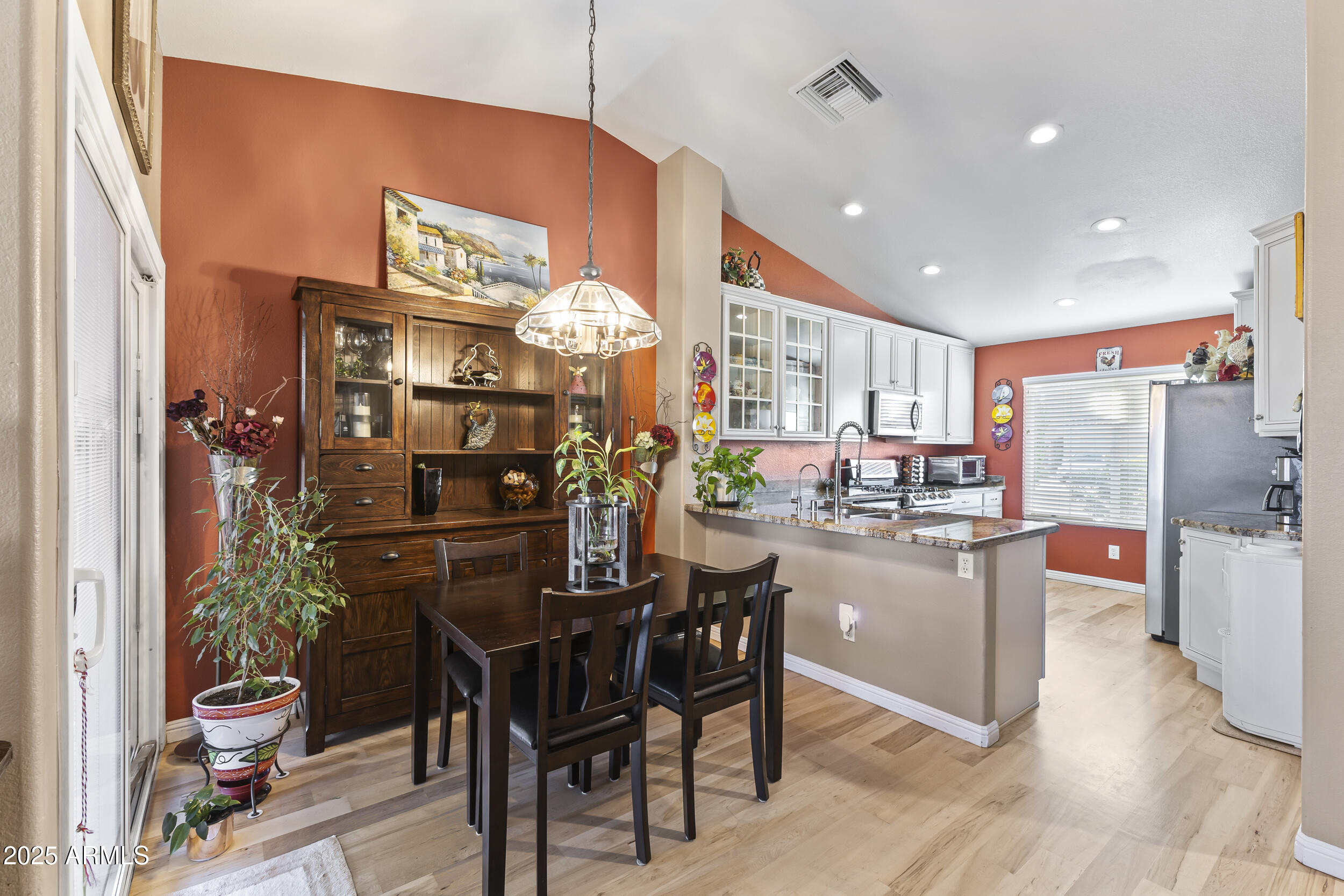 922 West Hudson Way Gilbert, AZ 85233 - Photo 9 of 27 a kitchen with stainless steel appliances kitchen island granite countertop a table and chairs in it