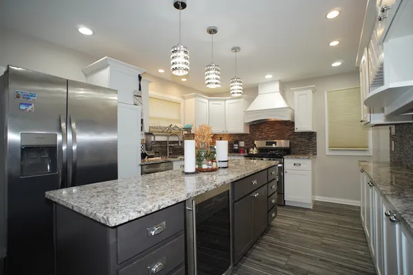 a kitchen with kitchen island granite countertop a center island and stainless steel appliances
