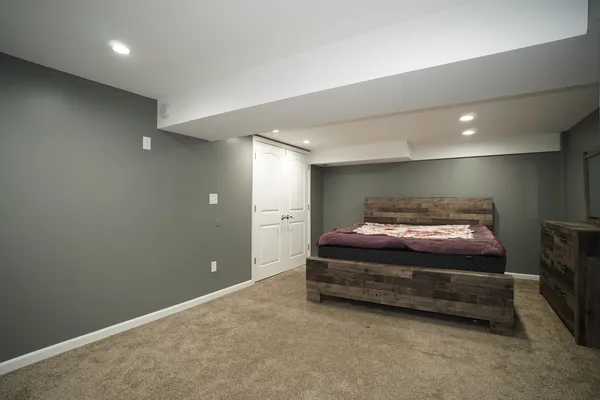 a spacious bedroom with a bed and a shower