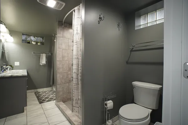 a bathroom with a shower and a toilet