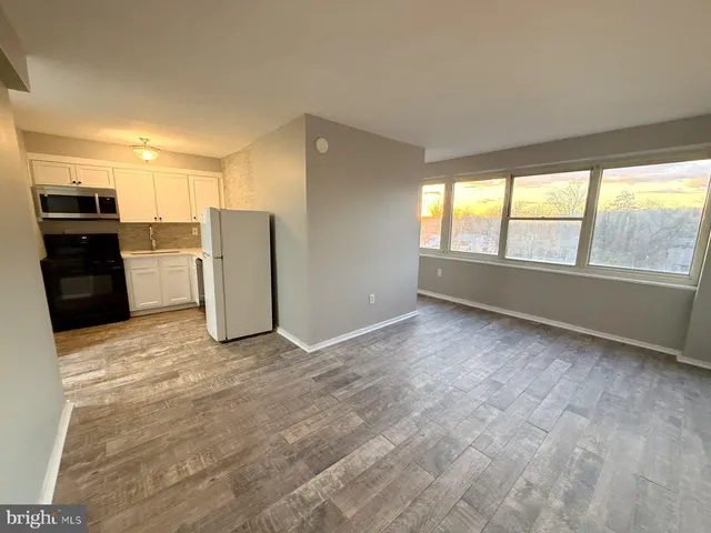 a view of a kitchen with a sink refrigerator and window