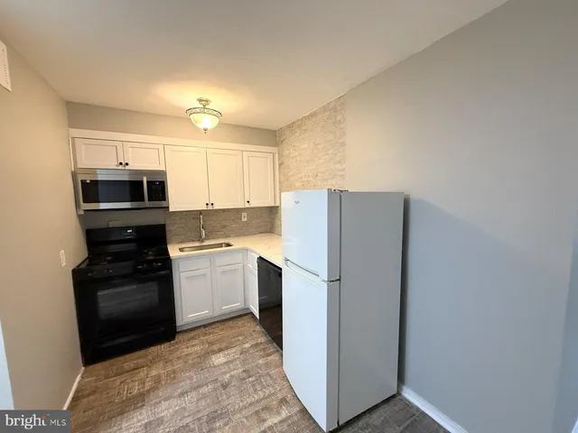 a kitchen with a refrigerator stove and microwave