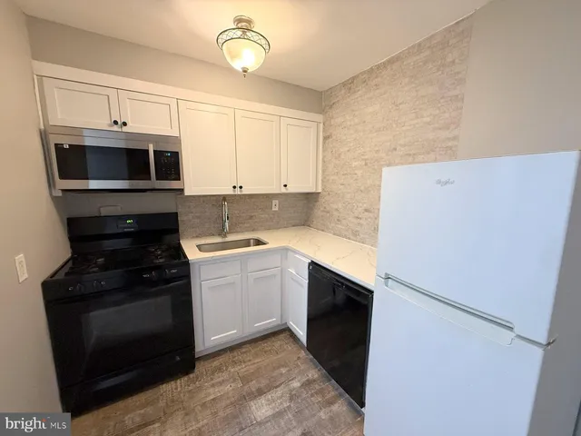 a kitchen with a refrigerator stove and microwave