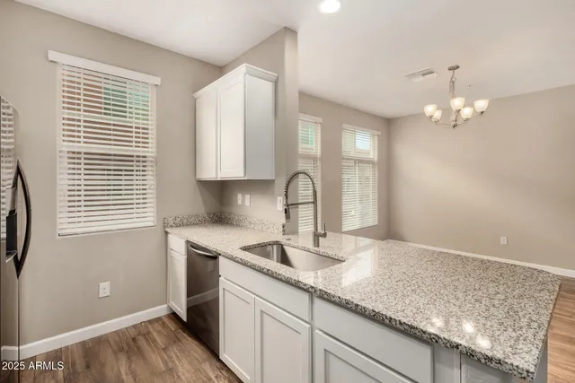 a kitchen with a sink cabinets and window