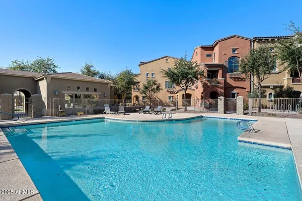 a view of a house with swimming pool and sitting area