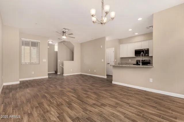 a view of a kitchen with a sink and stainless steel appliances
