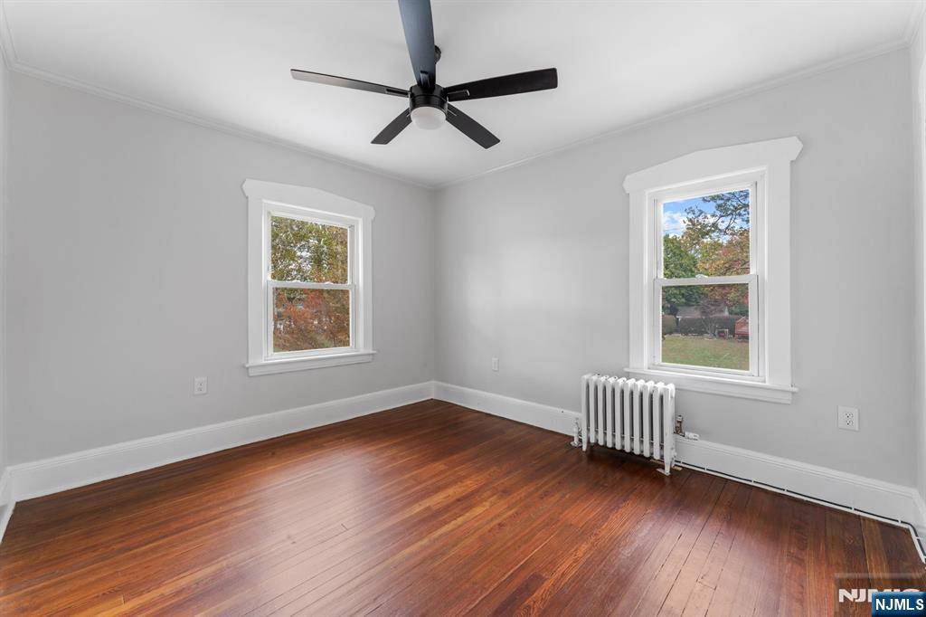 177 East Pierrepont Avenue Rutherford, NJ 07070 - Photo 22 of 27 a view of an empty room with wooden floor and a window