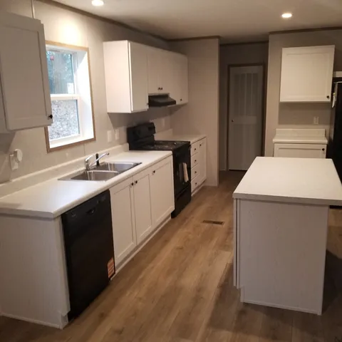 a kitchen with a sink stove and cabinets