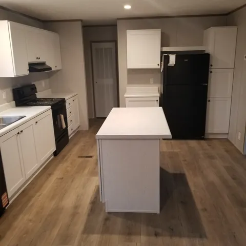a kitchen with a refrigerator and a stove