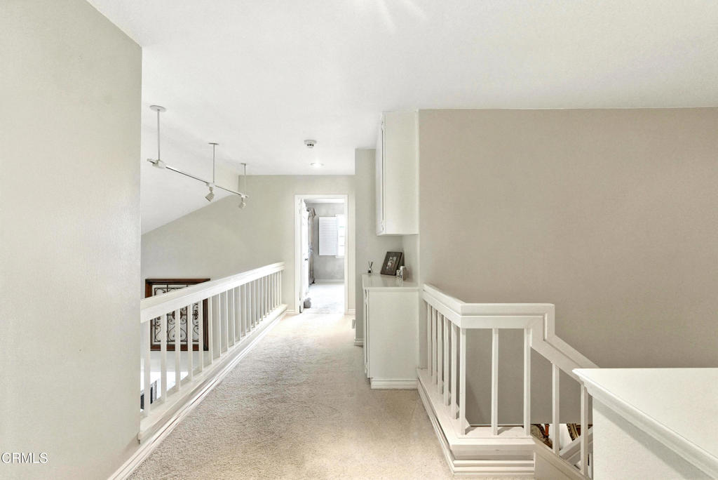 1095 Amberton Lane Thousand Oaks, CA 91320 - Photo 11 of 20 a view of a hallway with white walls and stairs