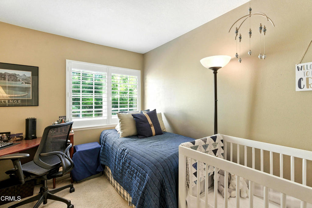 1095 Amberton Lane Thousand Oaks, CA 91320 - Photo 14 of 20 a view of a bedroom with furniture and a window