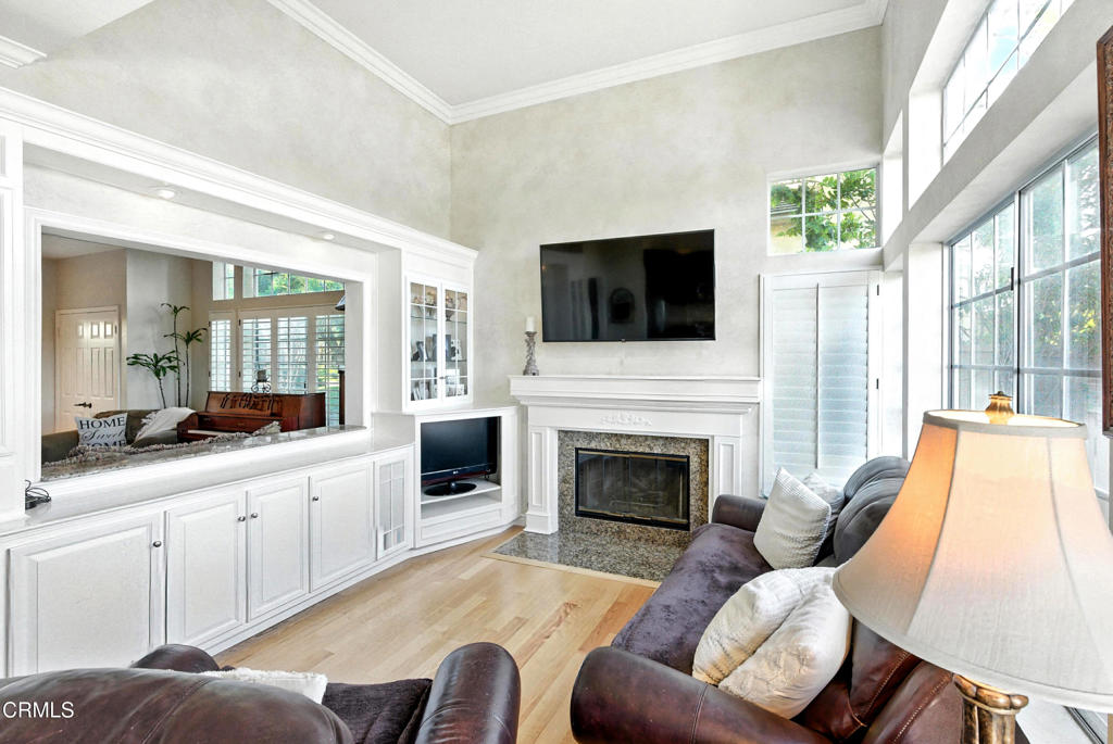 1095 Amberton Lane Thousand Oaks, CA 91320 - Photo 7 of 20 a living room with furniture a flat screen tv and a fireplace