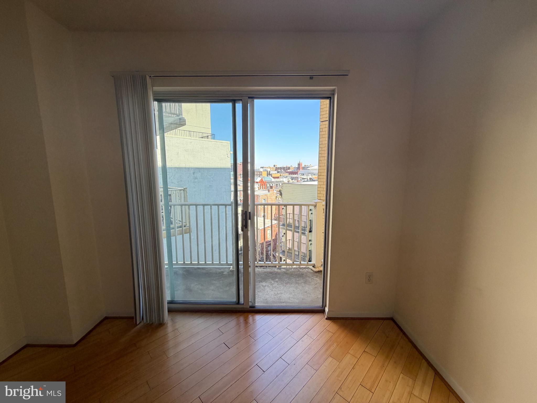 1111 11th Street Northwest, Unit 608 Washington, DC 20001 - Photo 15 of 29 a view of an empty room and wooden floor and a window