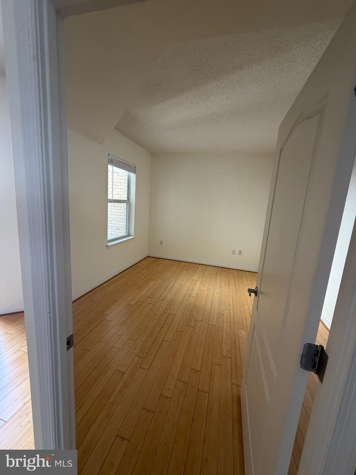 1111 11th Street Northwest, Unit 608 Washington, DC 20001 - Photo 16 of 29 wooden floor in an empty room with a window