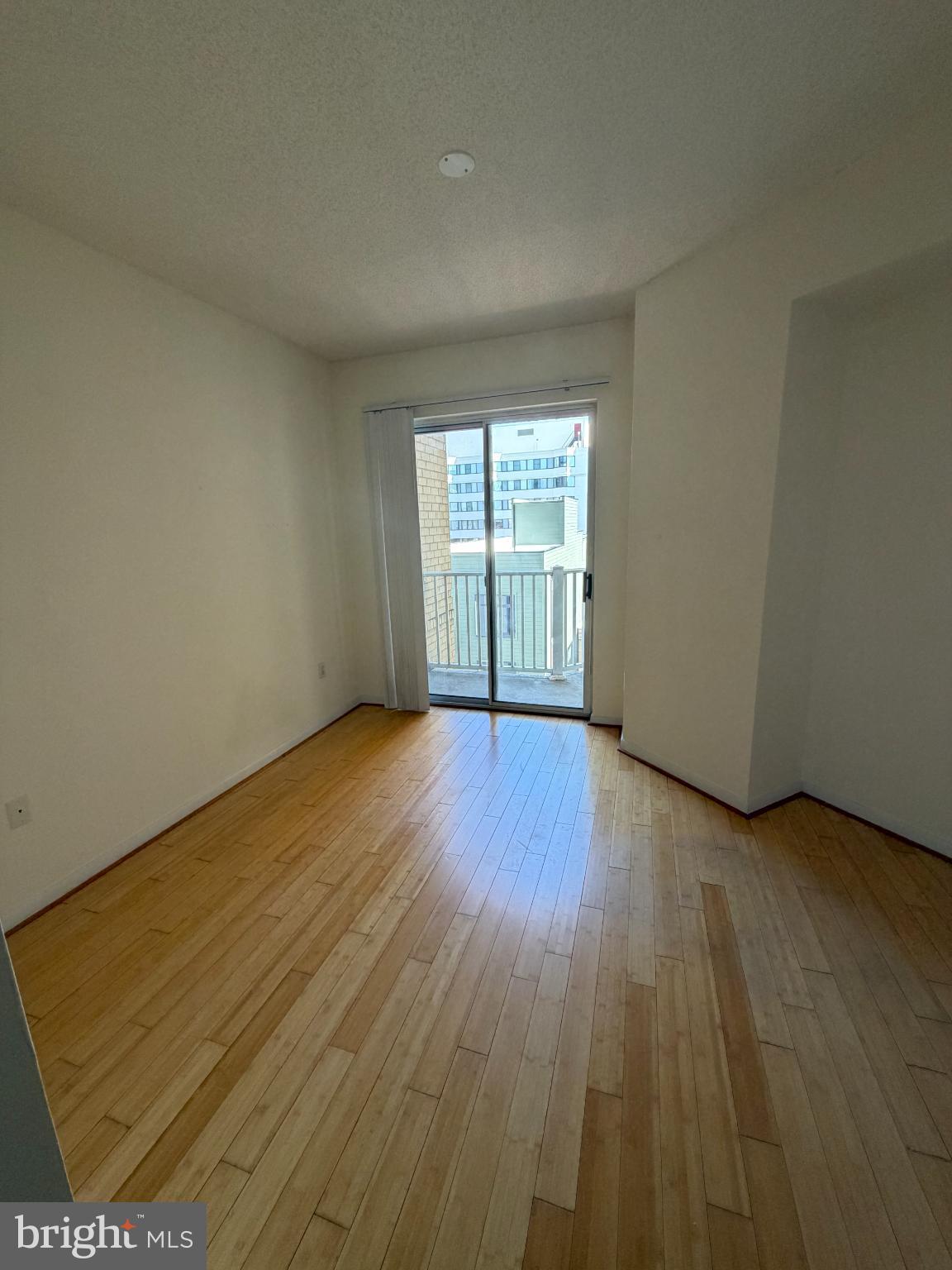1111 11th Street Northwest, Unit 608 Washington, DC 20001 - Photo 17 of 29 an empty room with wooden floor and windows
